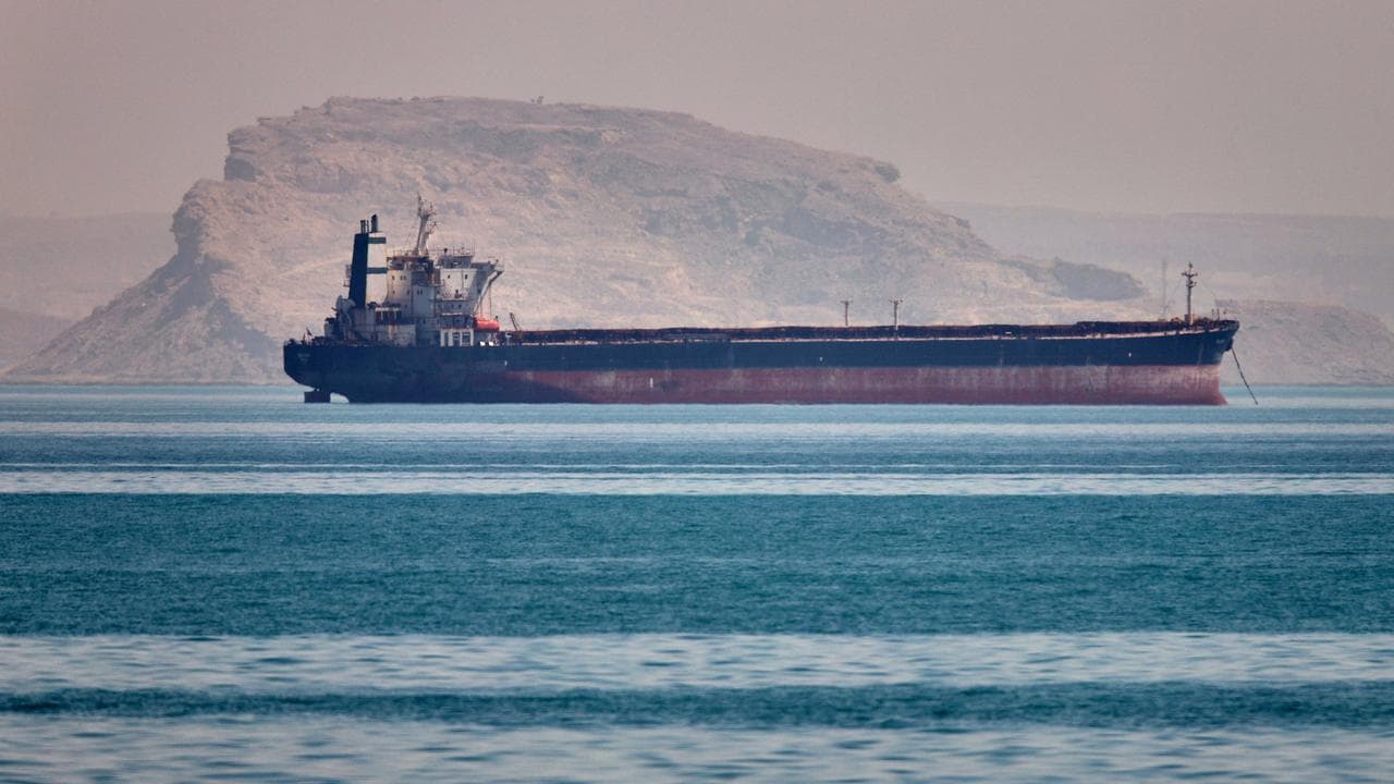 A bulk cargo ship sits at anchor in the Strait of Hormuz