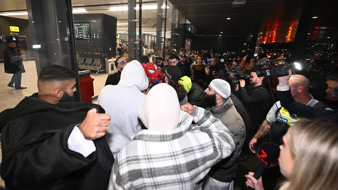 Supporters with an Islamic State-linked family at Melbourne airport