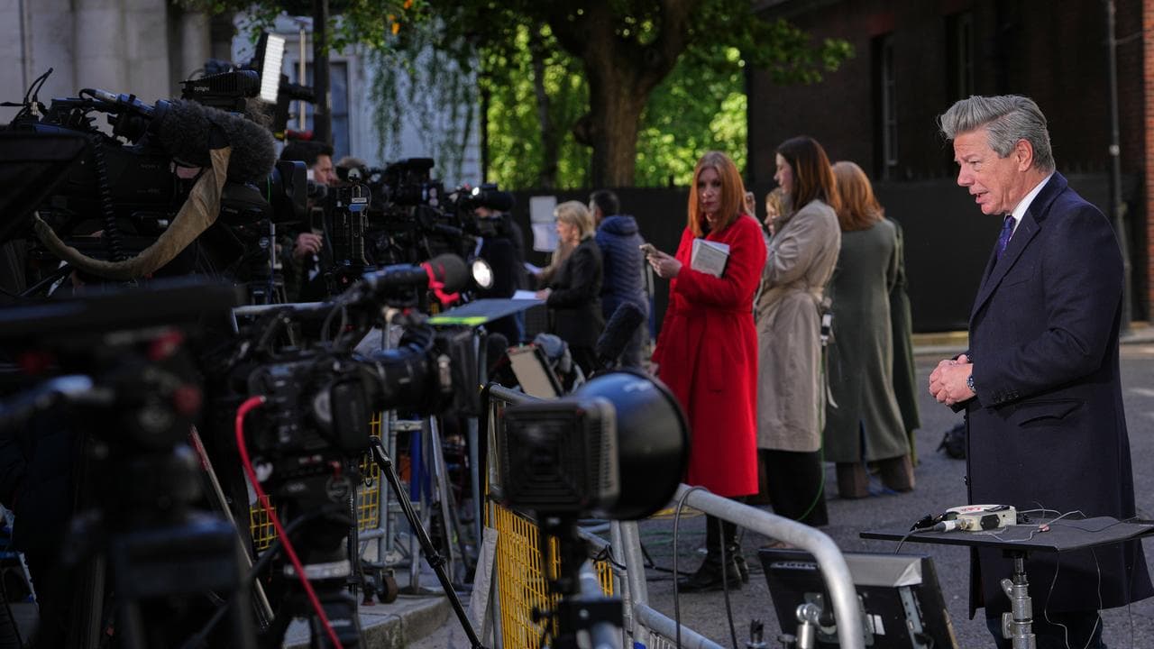 TV presenters report from Downing Street in London