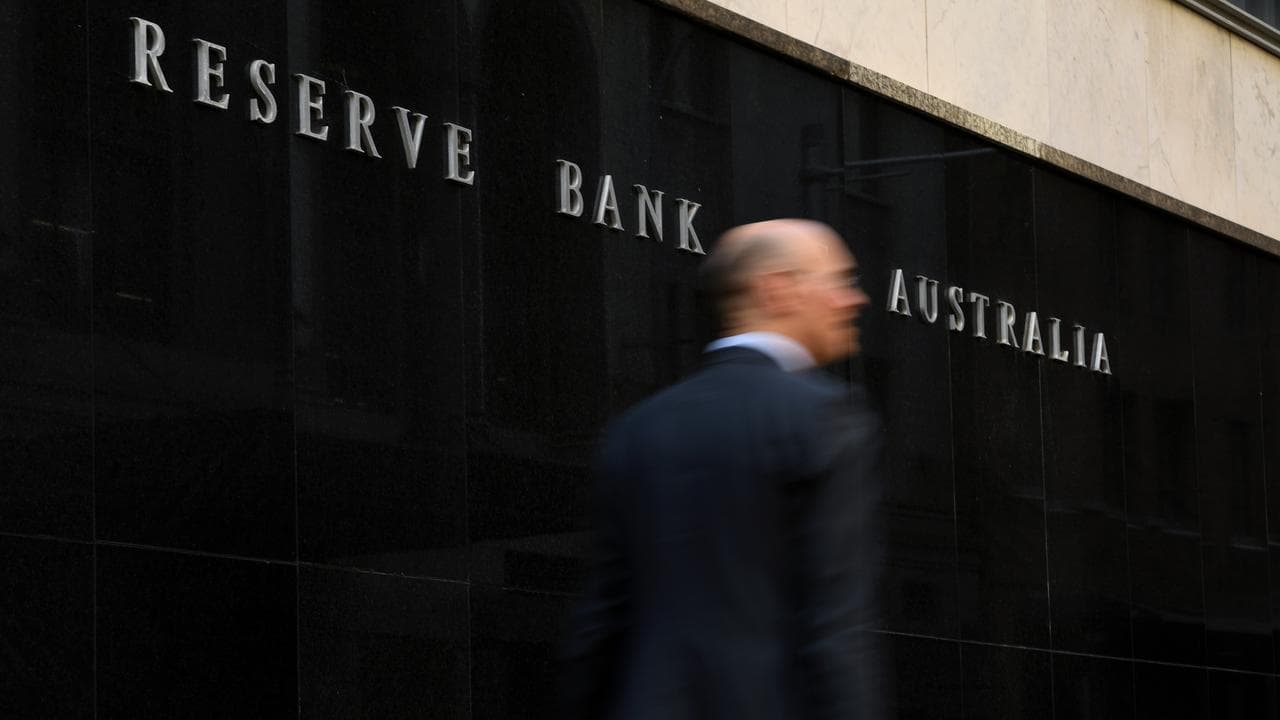 A man walks past the Reserve Bank of Australia building in Sydney