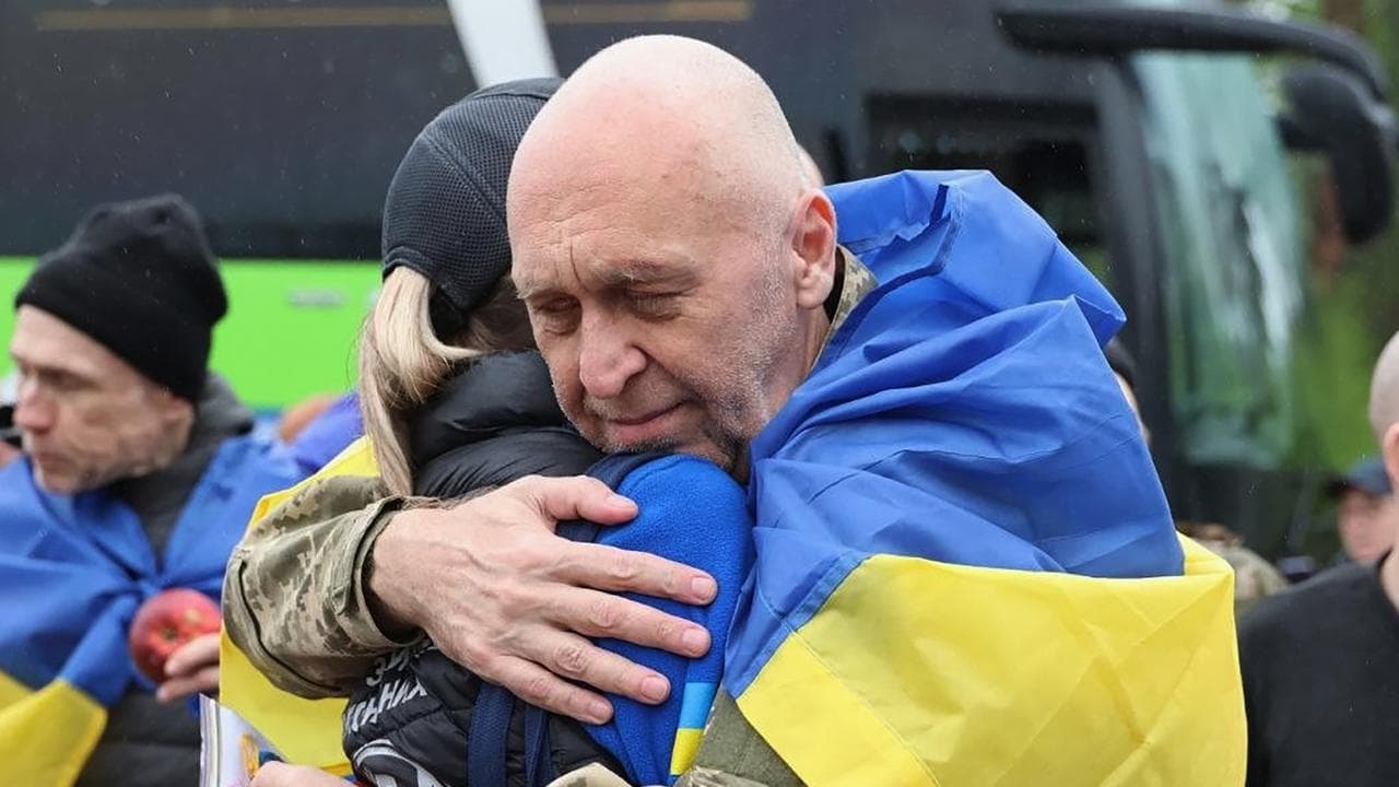 A Ukrainian soldier hugs a woman after a POW exchange with Russia