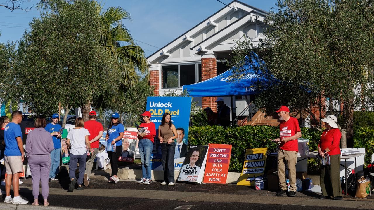 Candidate volunteers are seen at a polling booth in Brisbane