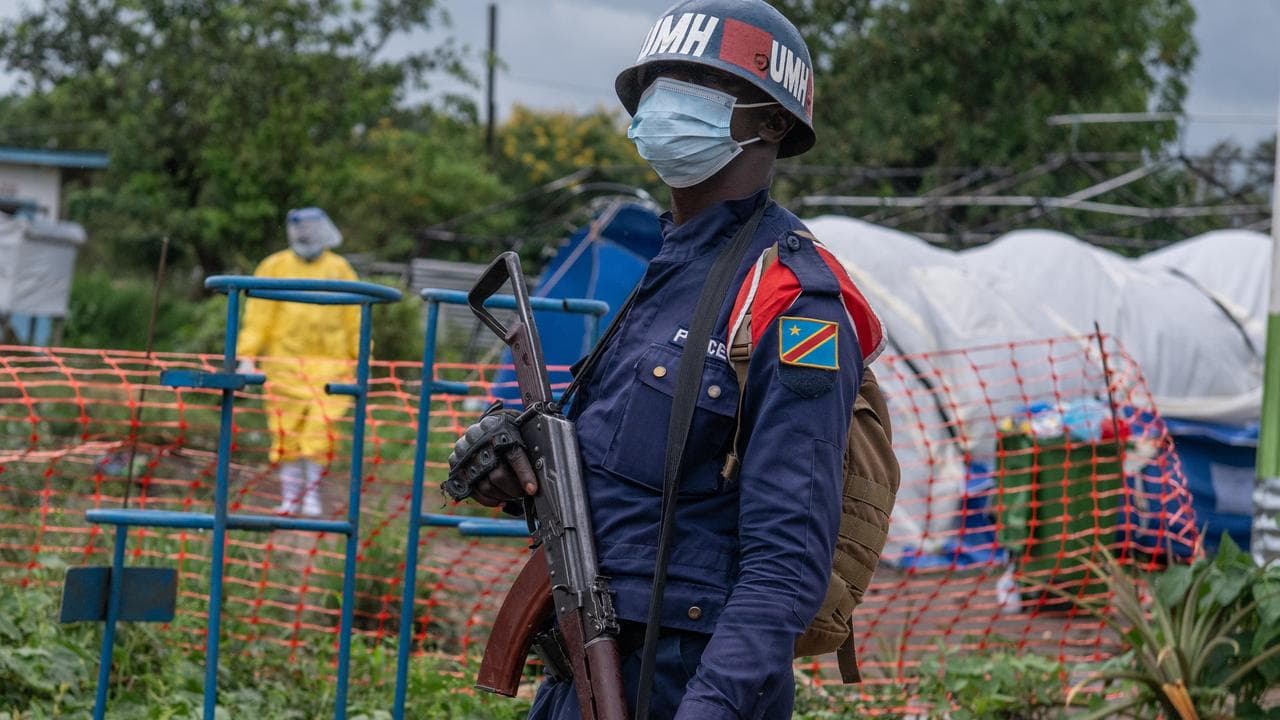 A Congolese police officer guards an Ebola treatment centre