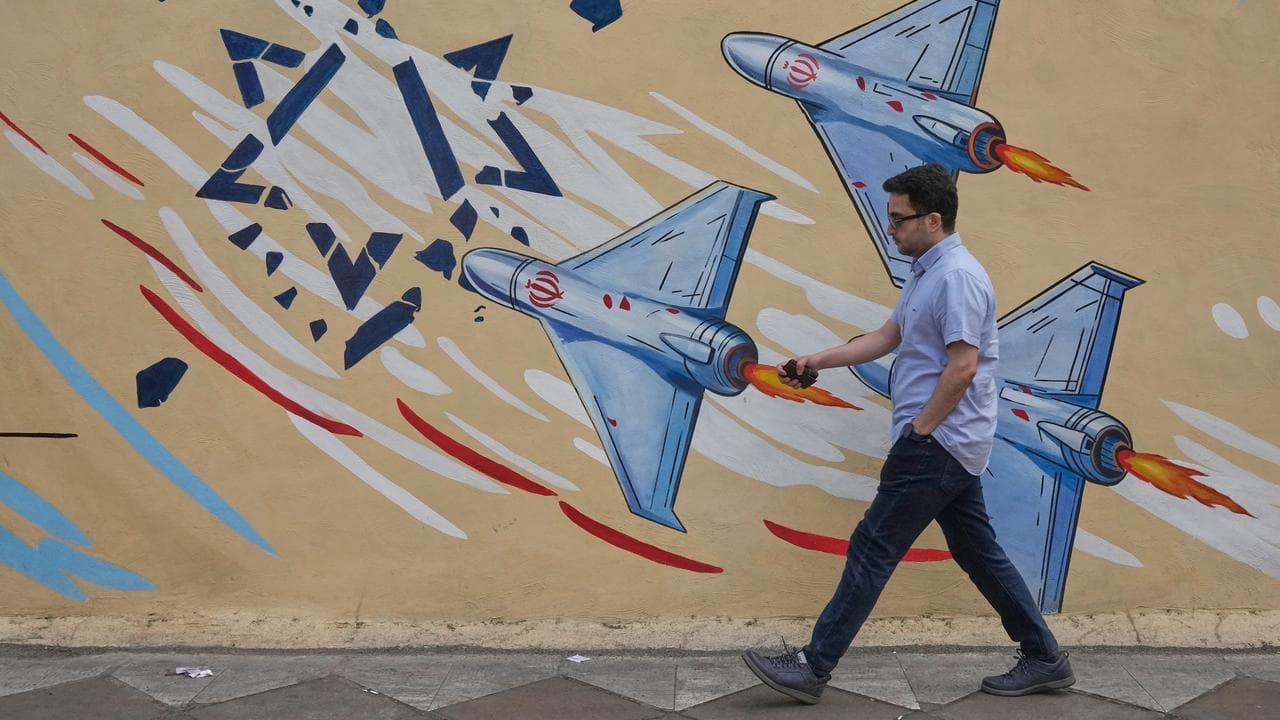 A man walks past an anti-Israel mural in Tehran (file image)