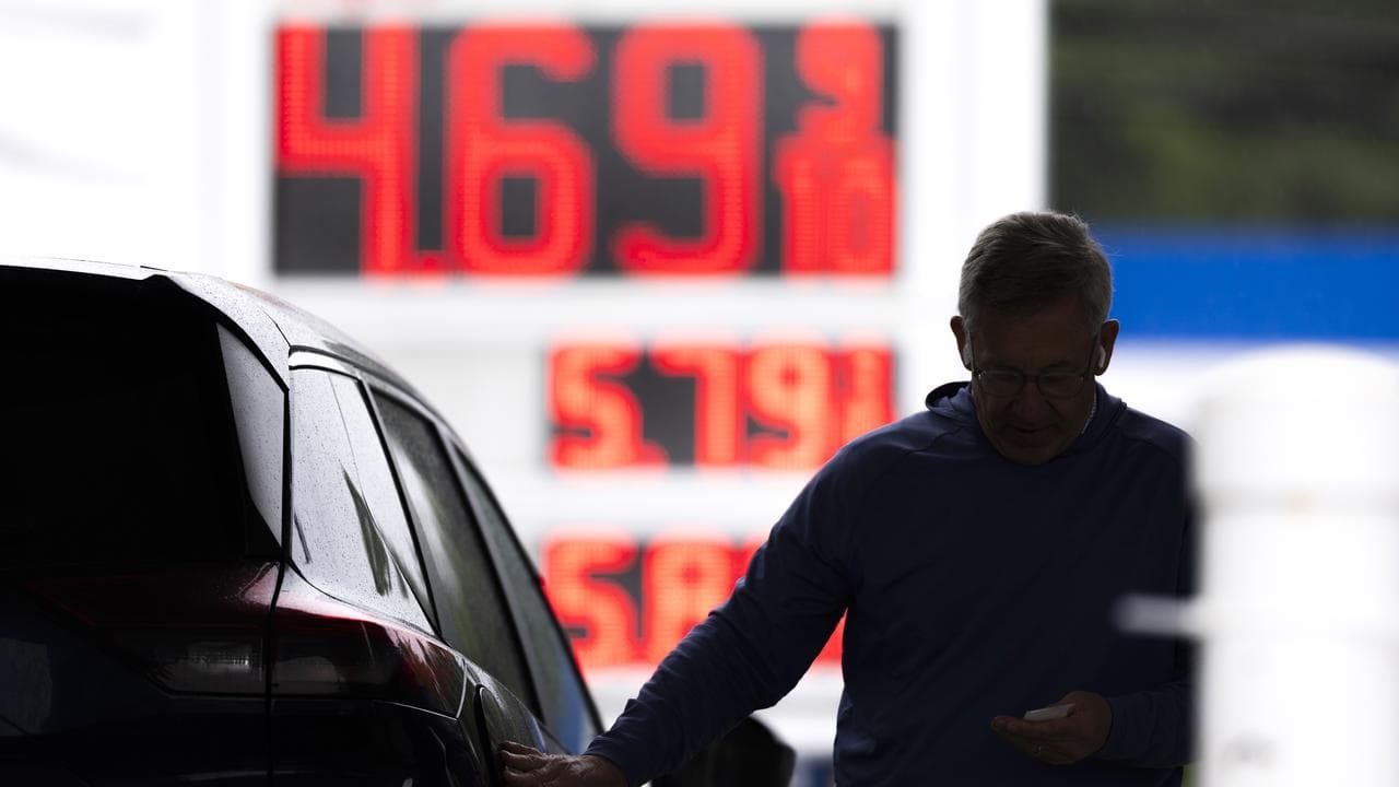 A motorist fills up their car at the petrol station