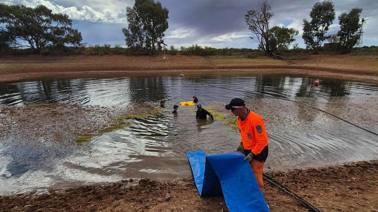 Police search a dam on the property