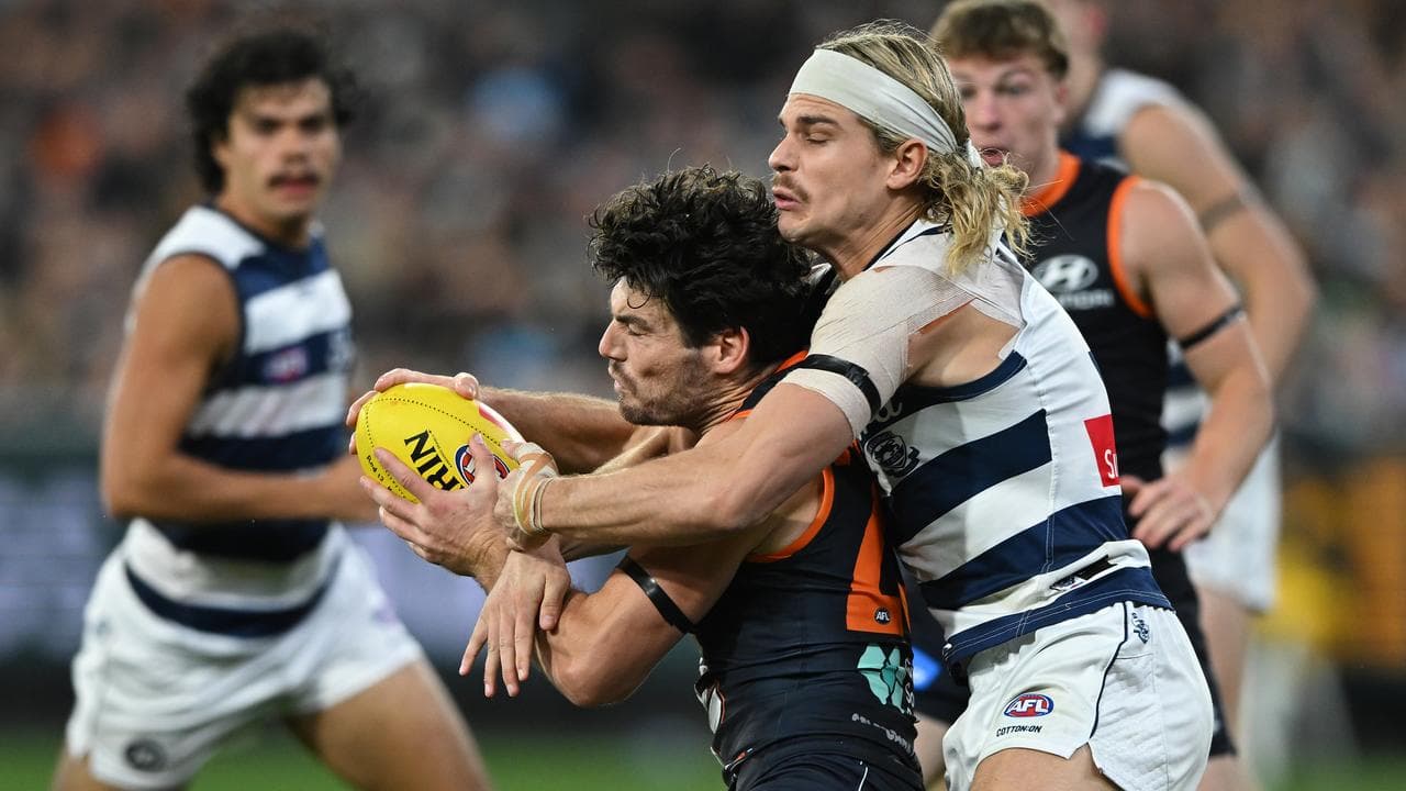 Bailey Smith of Geelong tackles George Hewett of Carlton