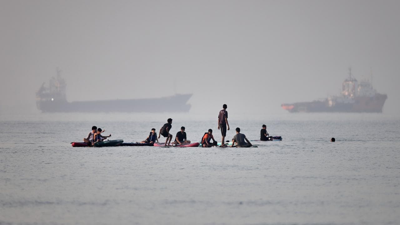 Cargo and service vessels are anchored in the Strait of Hormuz