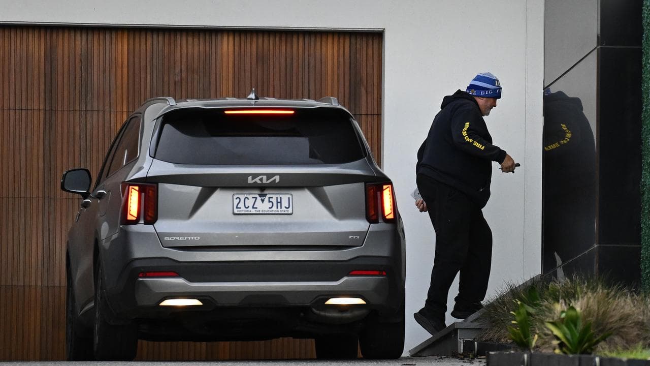 Mick Gatto arrives home.