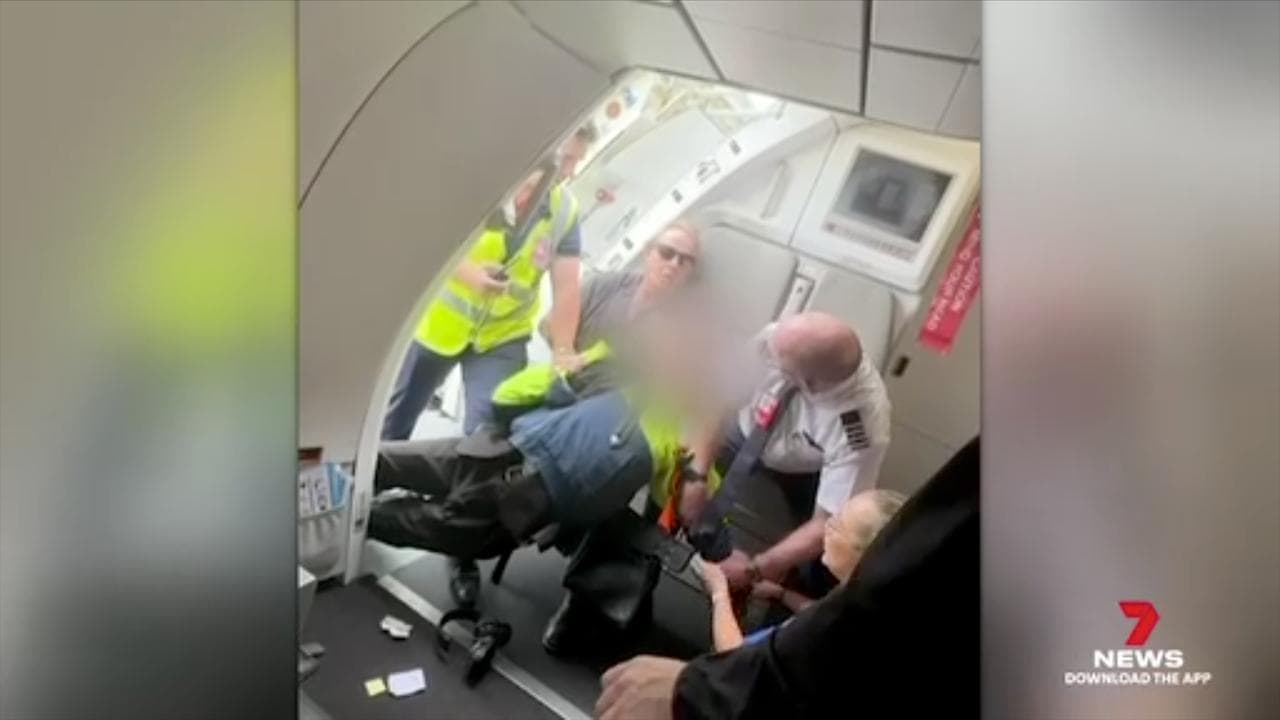 Teenager being restrained on the plane (file)