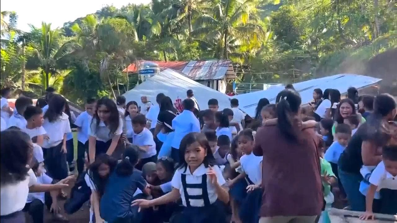 Schoolchildren afte an earthquake in Malita, Philippines