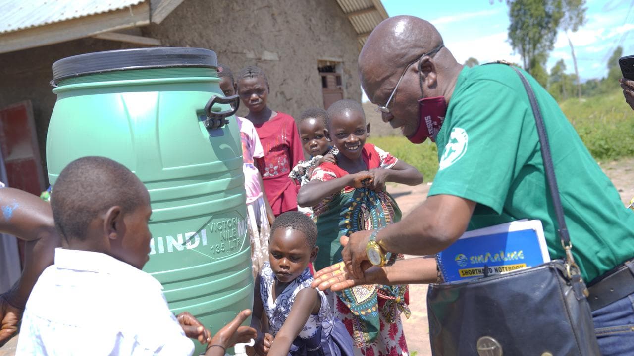 Villagers wash their hands in Rwanpara, Ituri