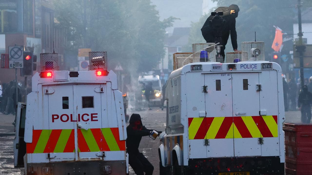Police vehicles come under attack from protesters in Belfast