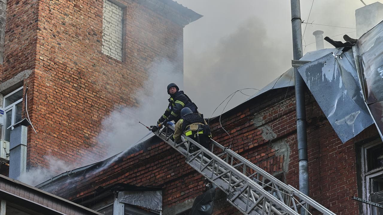 Ukrainian rescuers after a Russian drone strike in Kharkiv, Ukraine