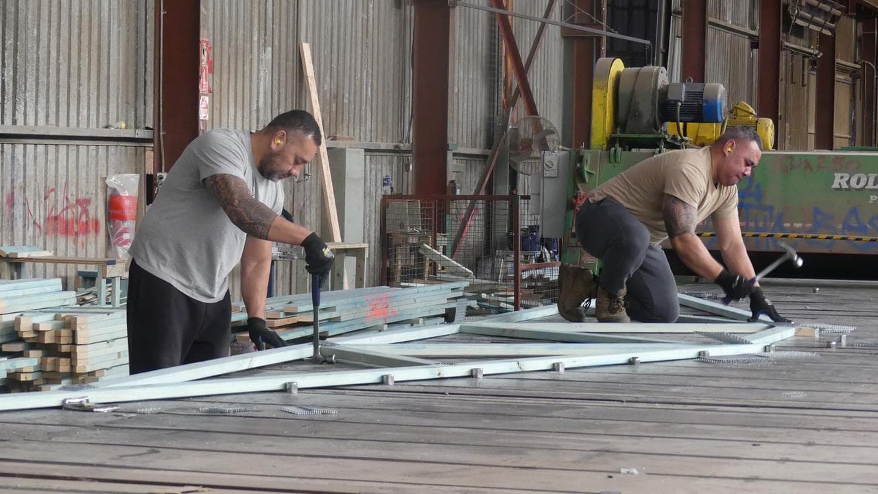 Workers construct house frames and trusses at the Westruss