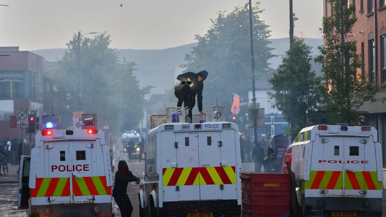 Police vehicles come under attack from protesters in Belfast