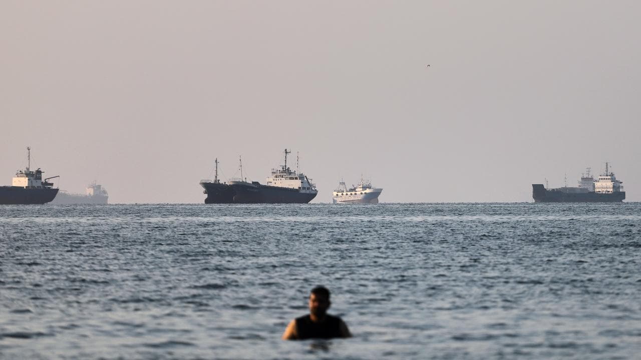 Cargo and commercial vessels are anchored in the Strait of Hormuz