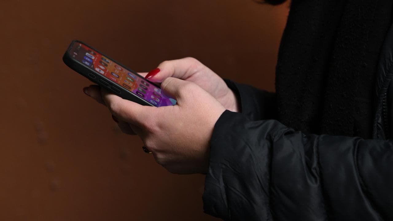 A person using a mobile phone with social media apps