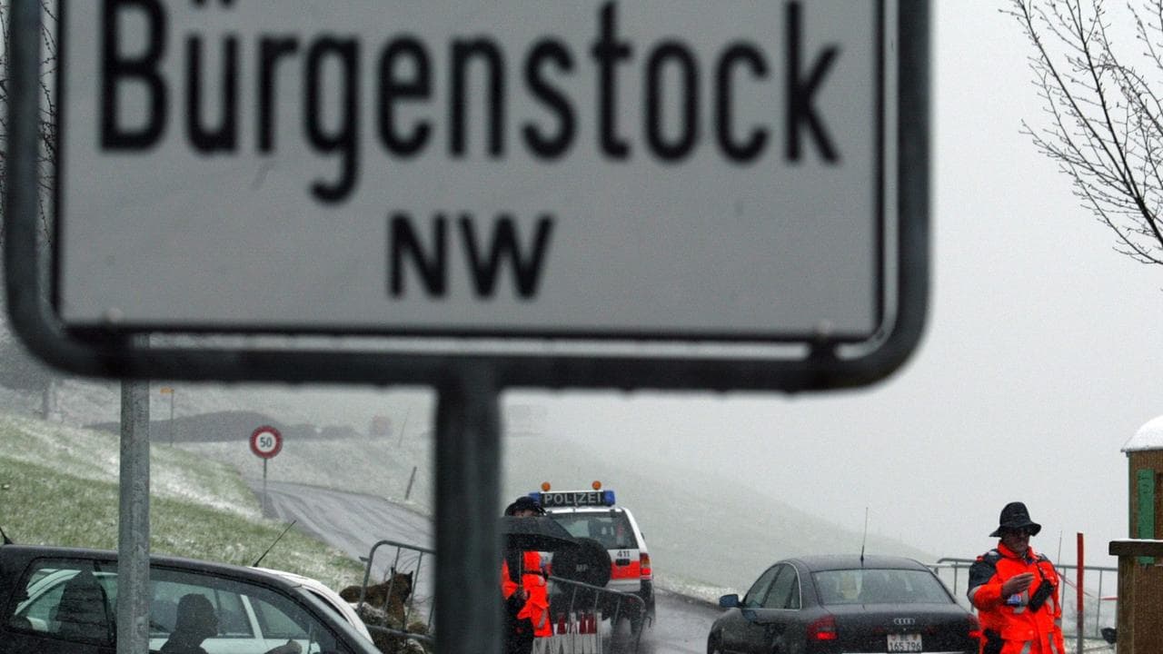 Policemen control cars heading for the resort of Buergenstock