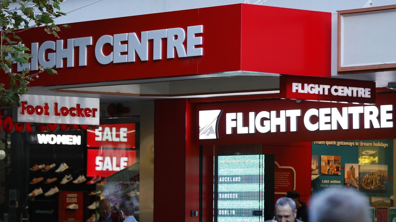 People walk in front of a Flight Centre store (file image)