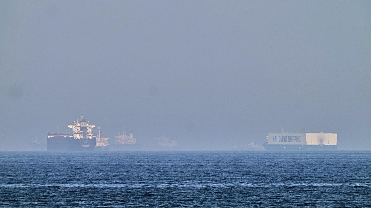 A tanker and a car carrier are anchored near the Strait of Hormuz