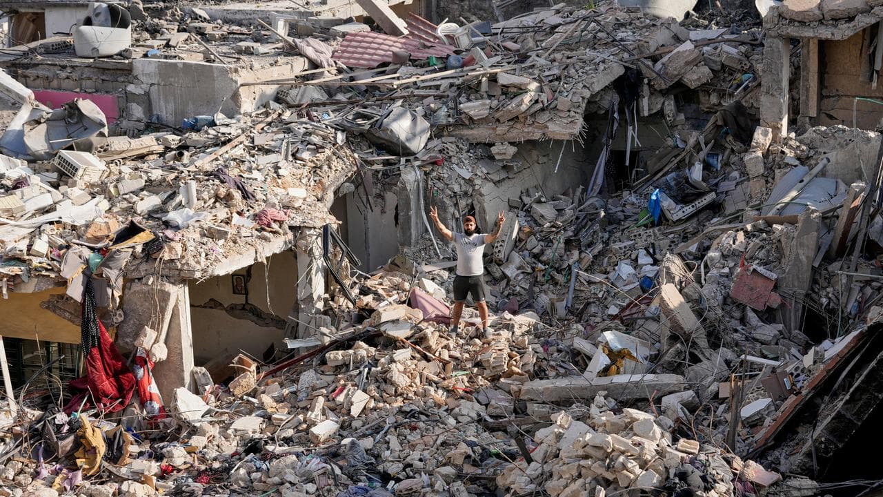 A villager stands in the rubble of his destroyed house in Lebanon