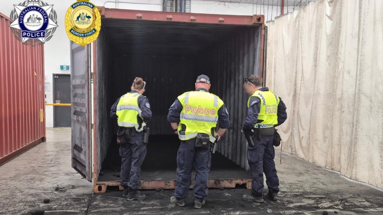 Police inspect a container