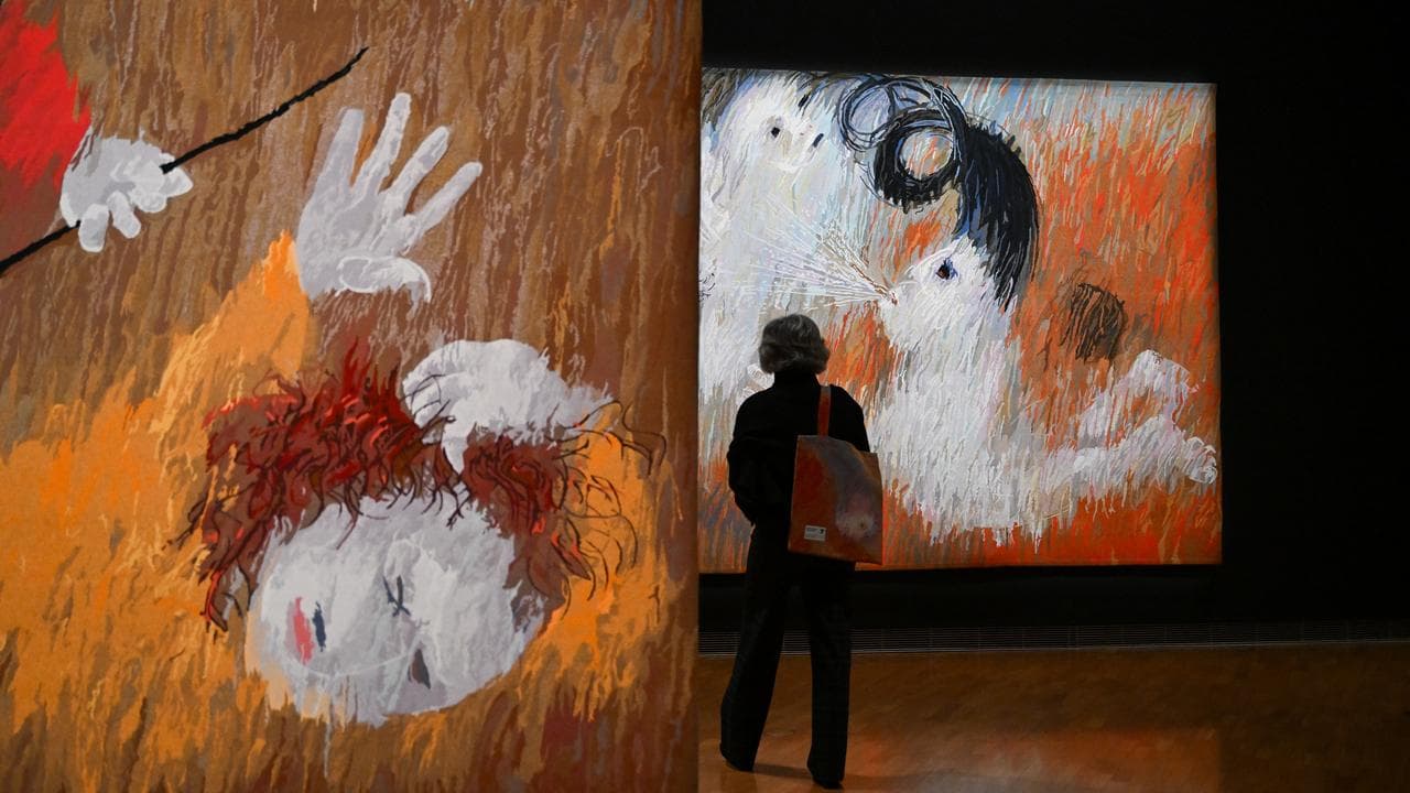 A guest takes a look at tapestries