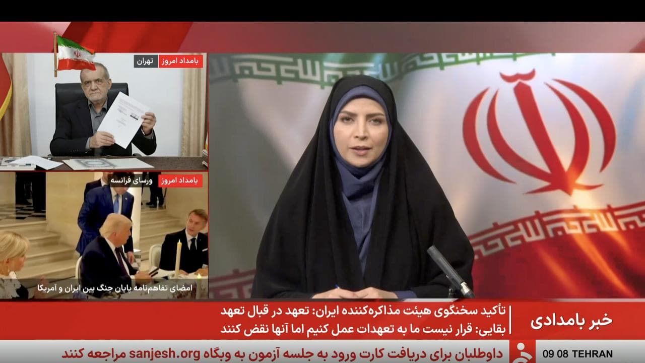 Iranian state TV shows signing of Iran-US deal to end war