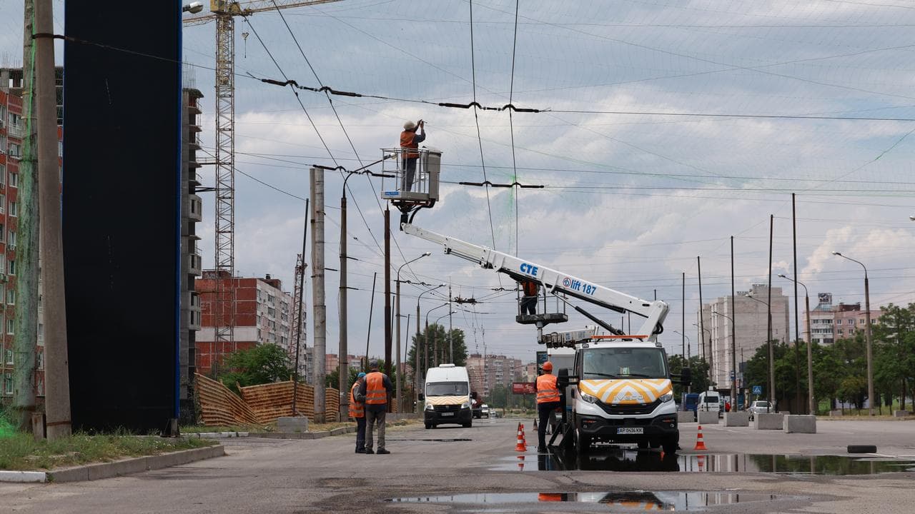 Municipal workers install anti drone nets