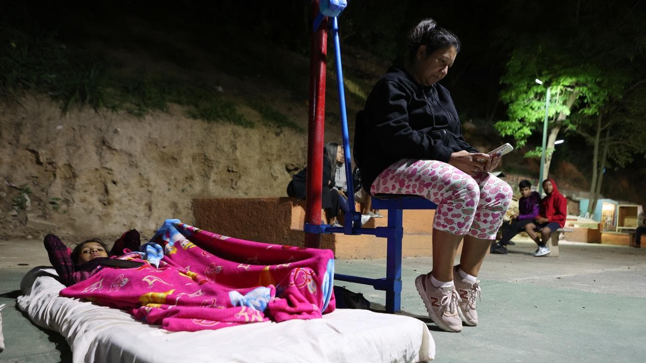 People camp on a sports court after earthquakes in Caracas, Venezuela