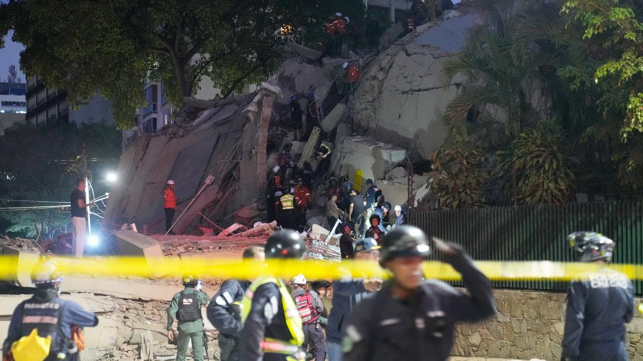 Rescue workers at a collapsed building after an earthquake in Caracas