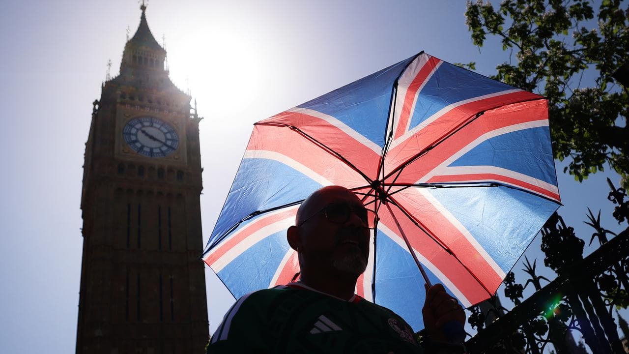 A man shleters from the sun in London