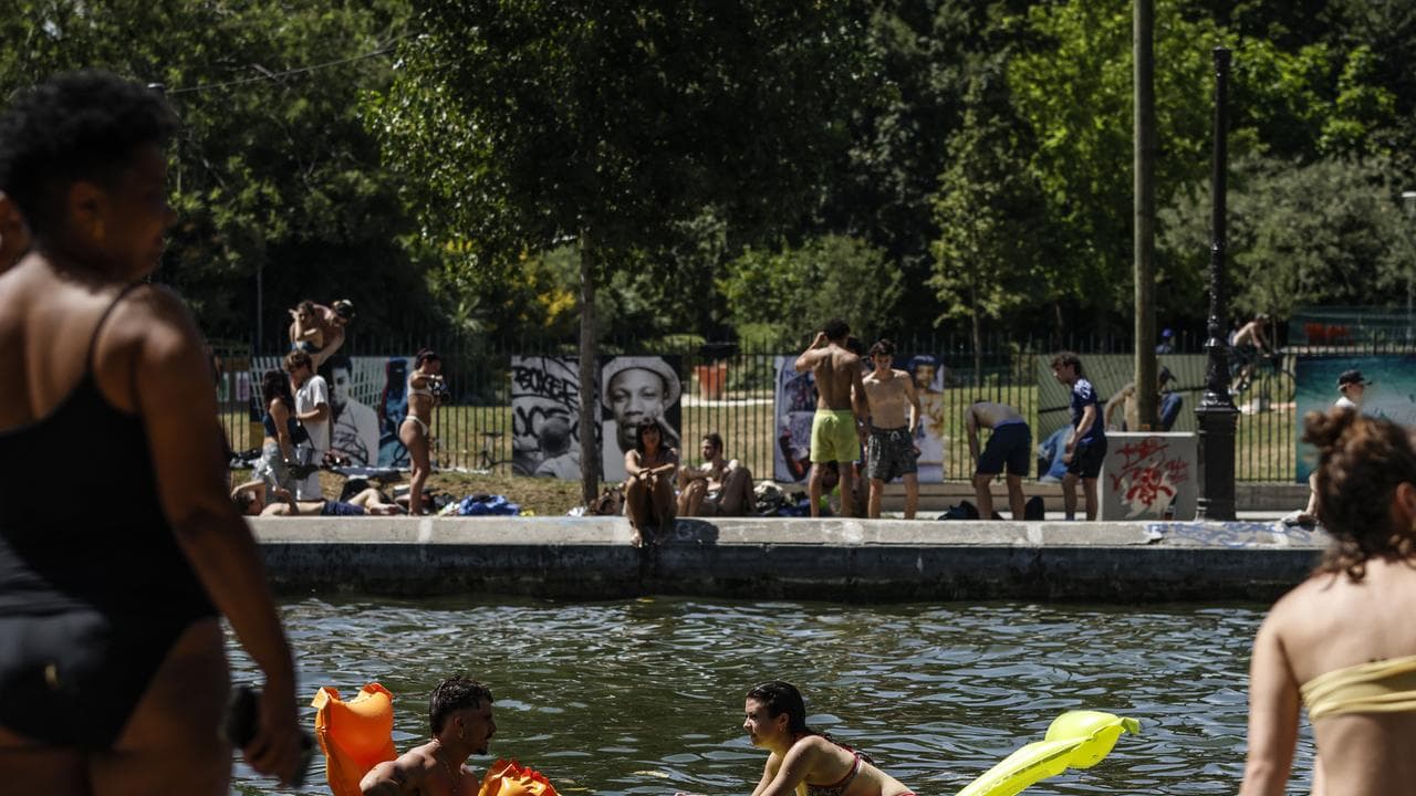 People cool off along the Canal Saint-Martin in Paris