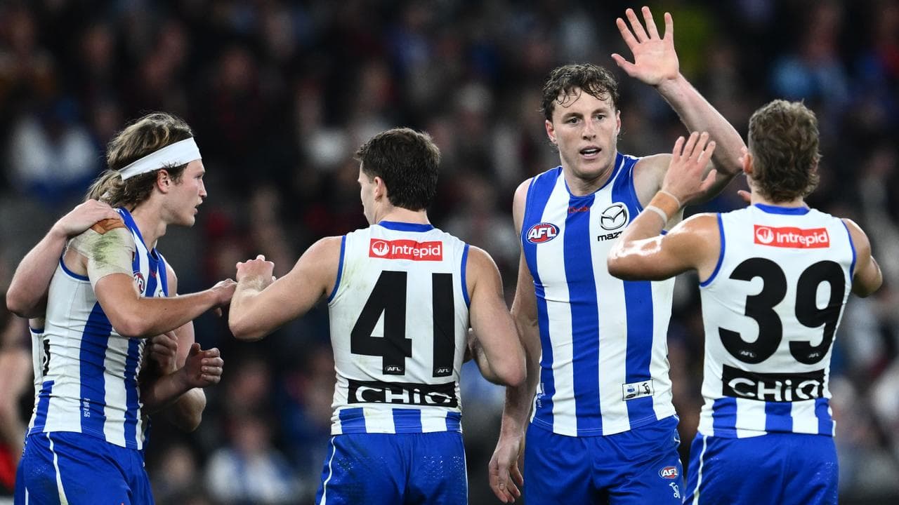 North Melbourne players celebrating.