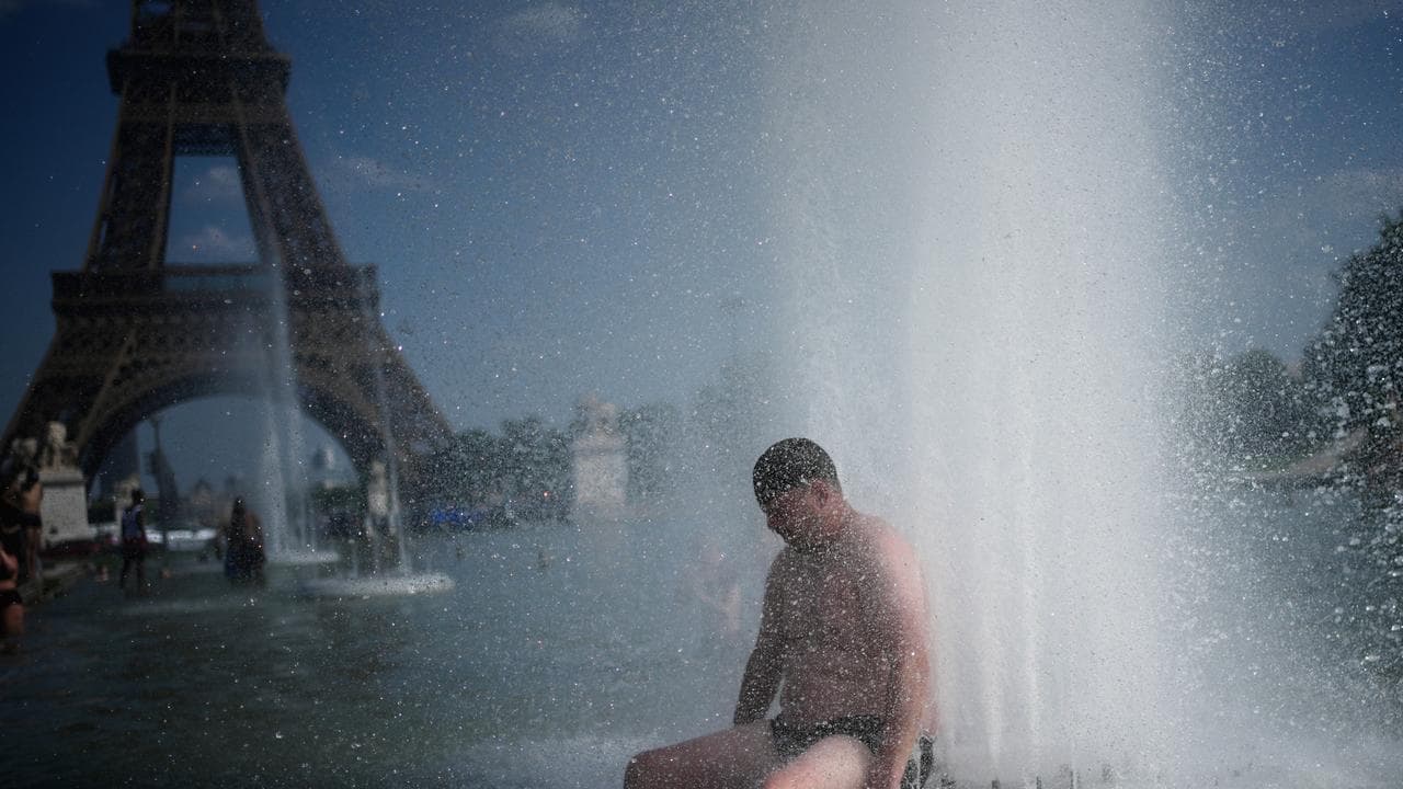 A person cools off at Trocadero fountain, Paris