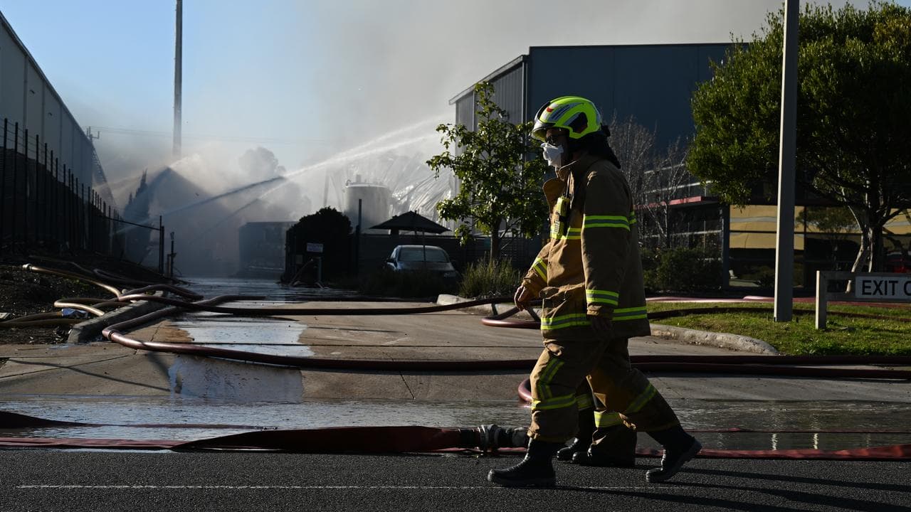Firefighters walk past the damaged factory (file image)