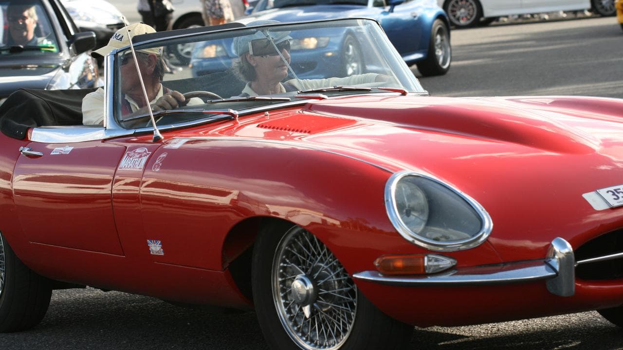 A classic Jaguar car in a convoy in Brisbane.