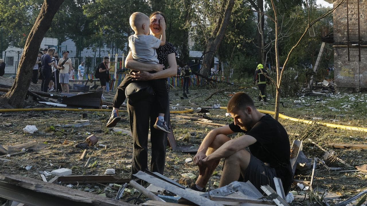 People react at the site of a Russian missile strike in Kyiv, Ukraine