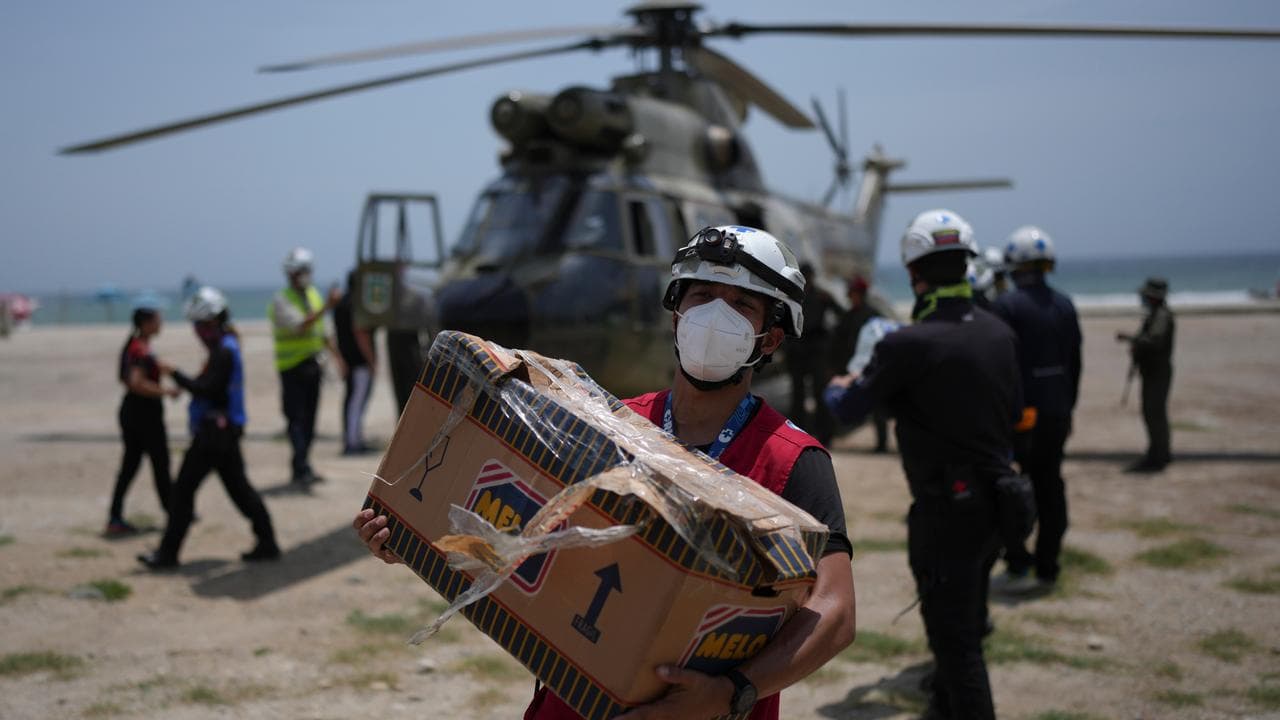 Rescue workers unload humanitarian aid in La Guaira, Venezuela