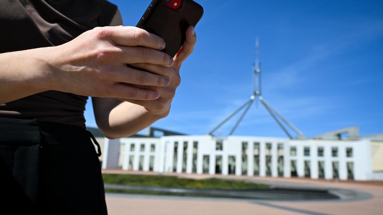 Woman on phone outside parliament.