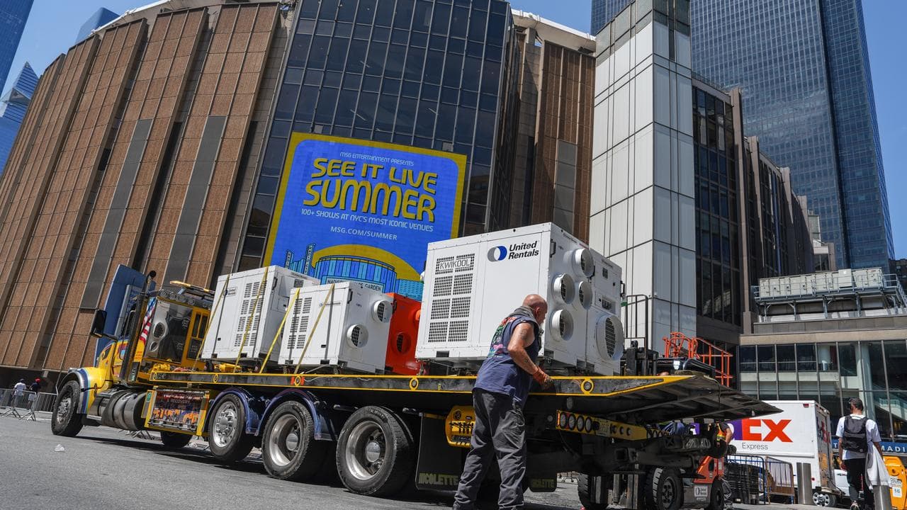 A worker unloads air-conditioning units at Madison Square Garden
