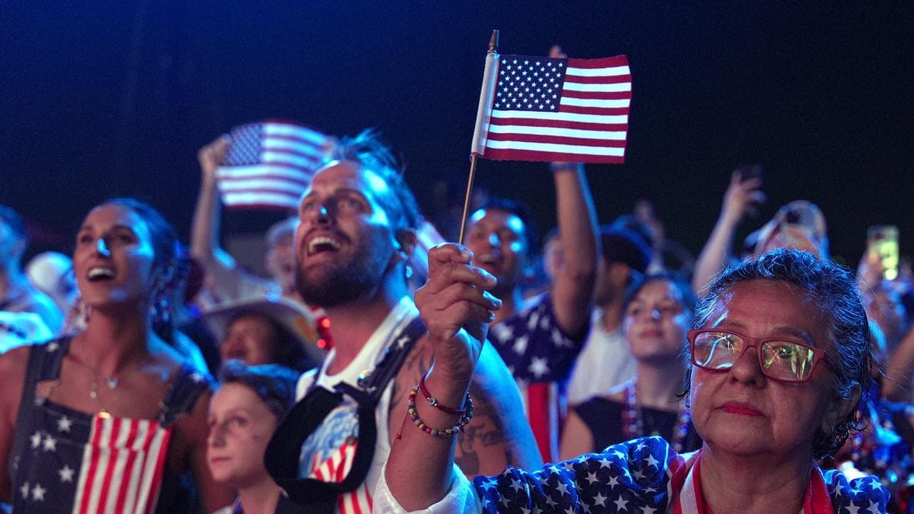 Guests in American flag-themed clothes attend Salute to America,