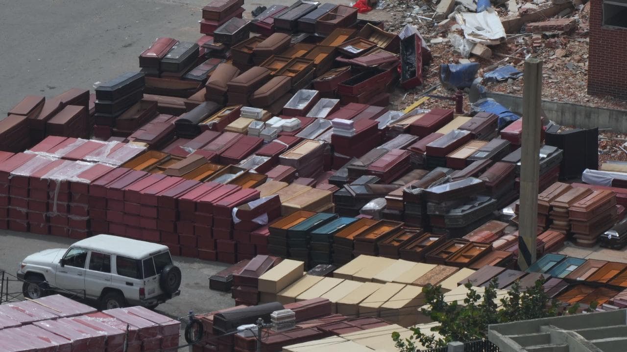 Coffins are stacked at the seaport