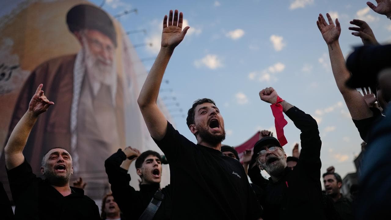 Mourners chant slogans while gathered in Islamic Revolution Square