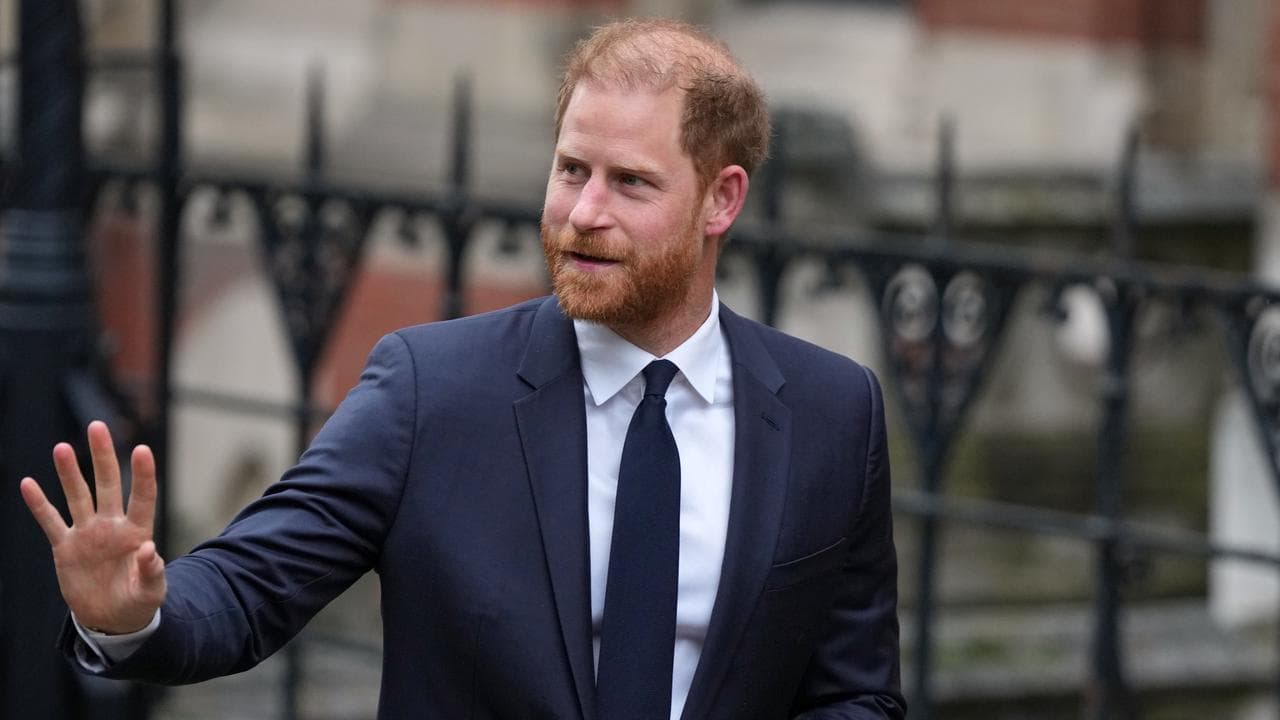 Britain's Prince Harry waves as he arrives at London's High Court