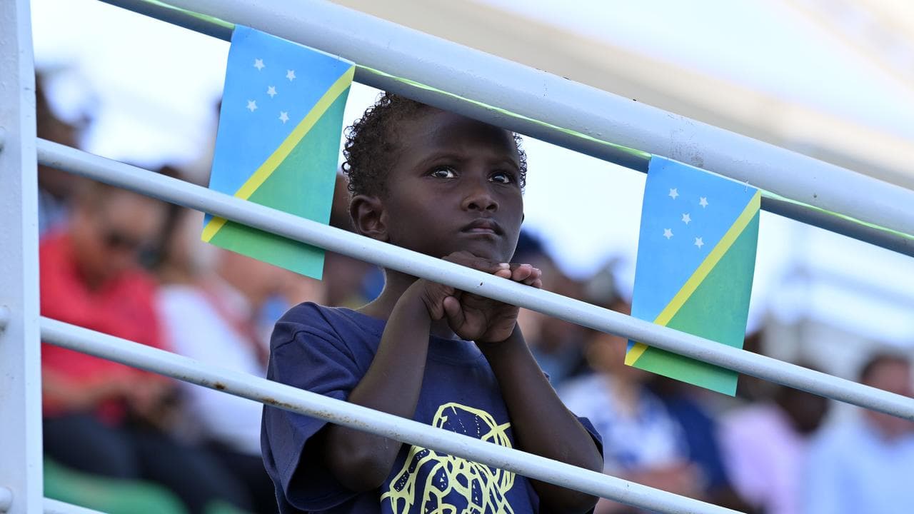 A child watches festivities during Independence Day
