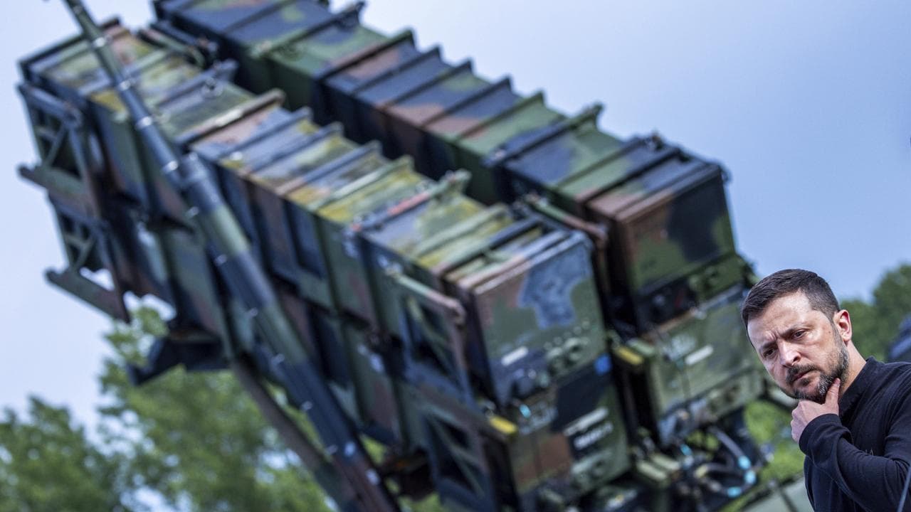 Ukraine's Volodymyr Zelenskiy and a Patriot air defence missile system