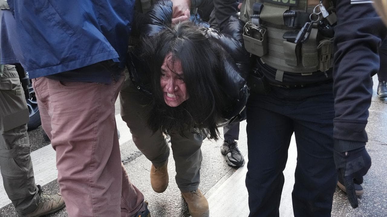 A person is detained by federal agents in Minneapolis
