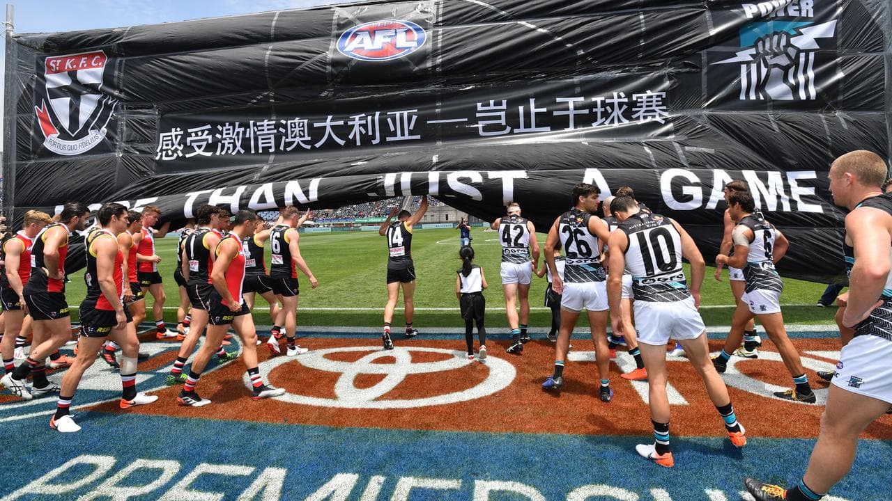 Players run through banner.